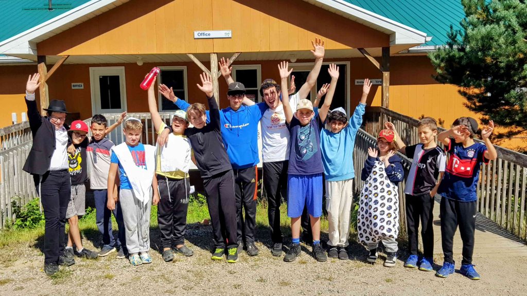 group photo at camp chai in front of cabin