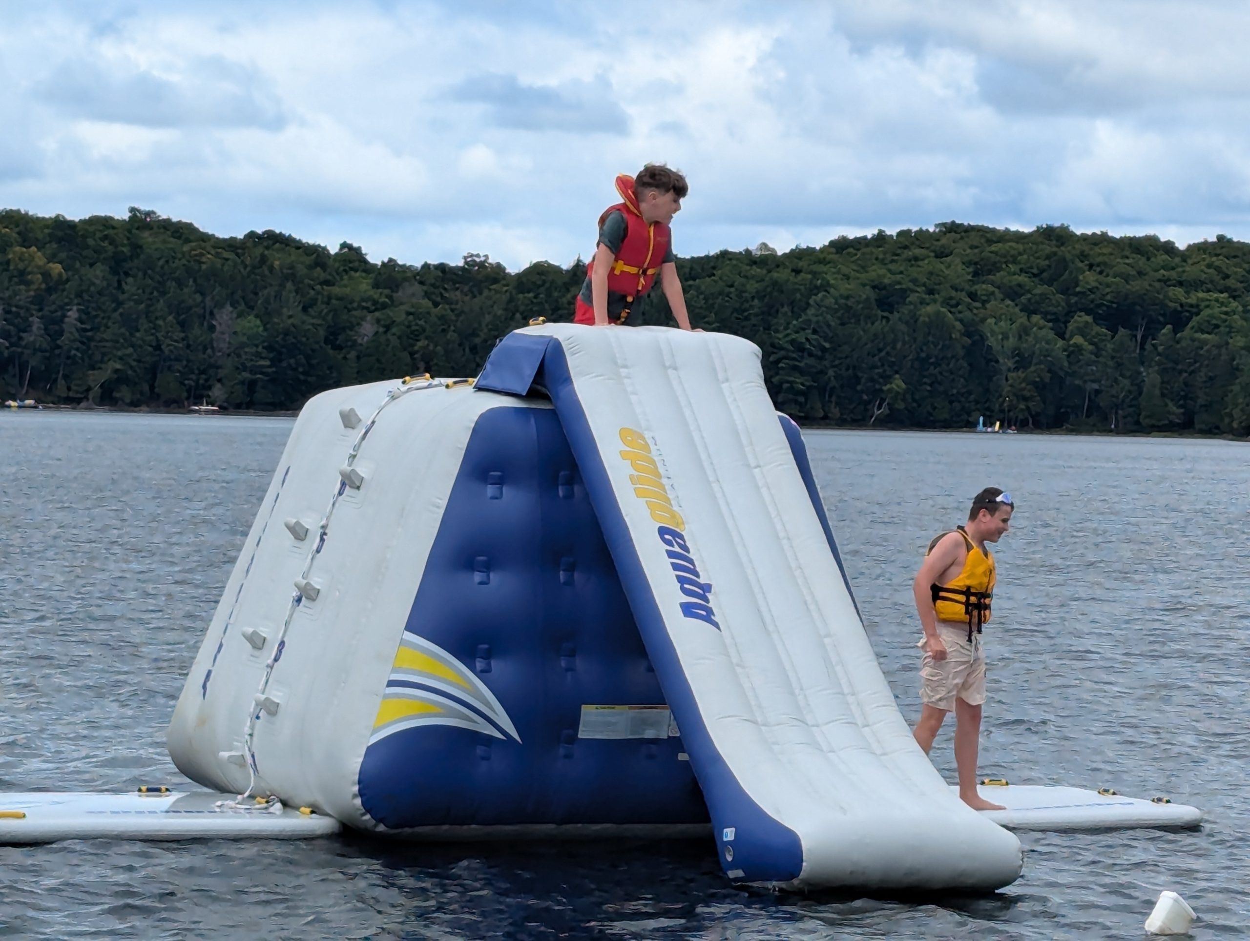 inflatable water slide in the middle of a lake.